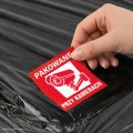 Etykieta Pakowane przy kamerach na paczce